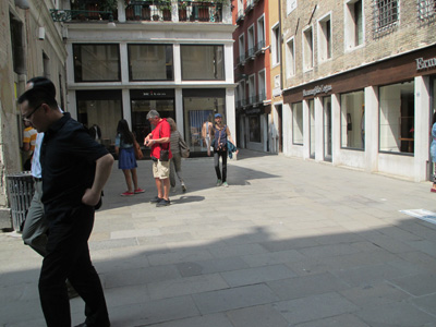11 photos show crowded streets and alleys 8 to 20 feet wide between 3- and 4-story buildings.